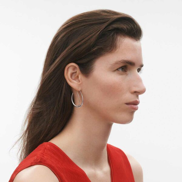 GJ-SS25-ECOM-SHOOT-OFFSPRING-EARRING-10012755-1200w-100KB Georg Jensen Offspring Double Earhoops in sterling silver on model wearing red dress | Kneen & Co