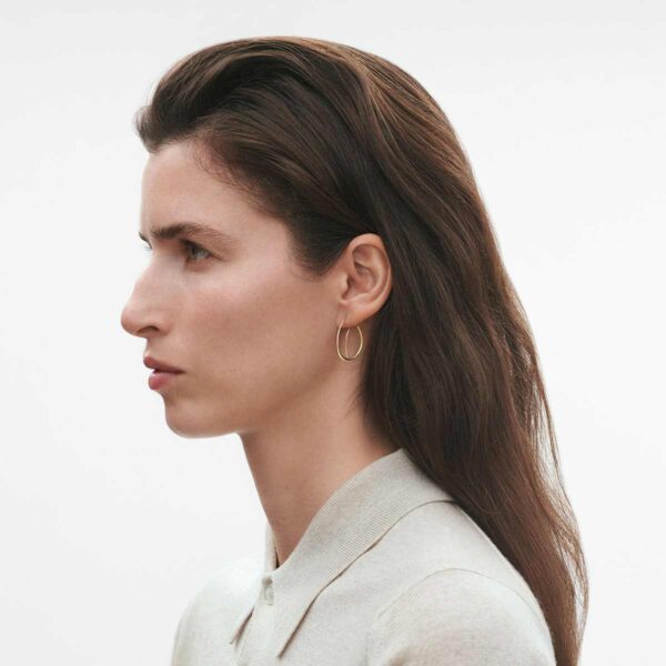 Georg Jensen Offspring Double Earhoops in 18 kt yellow gold on model | Kneen & Co