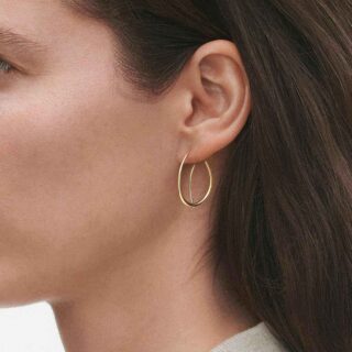 Georg Jensen Offspring Double Earhoops in 18 kt yellow gold close up on model | Kneen & Co