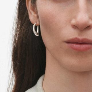 Georg Jensen Offspring Medium Earhoops Silver on model | Kneen & Co