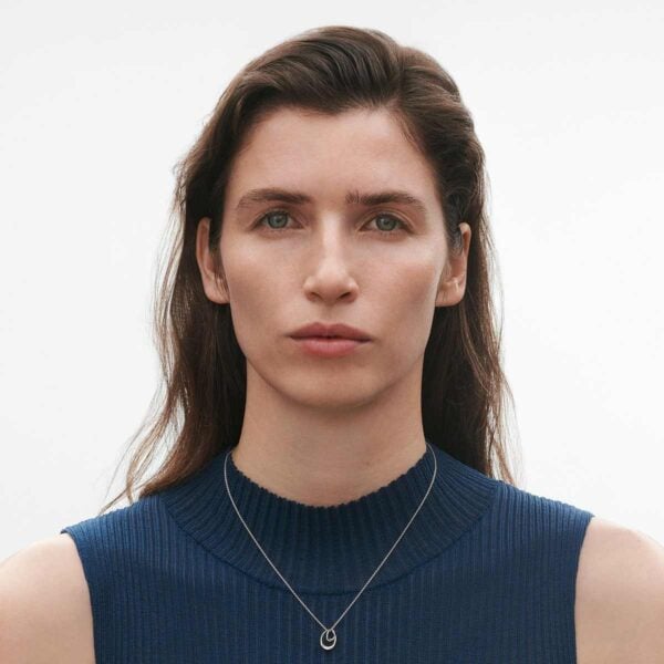 Woman wearing Georg Jensen Offspring Necklace with Pendant, Small in sterling silver | Kneen & Co