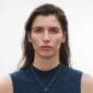 Woman wearing Georg Jensen Offspring Necklace with Pendant, Small in sterling silver | Kneen & Co