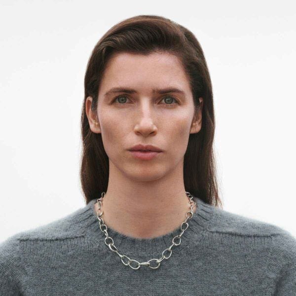 Georg Jensen Offspring Necklace in sterling silver on model wearing gray sweather | Kneen & Co