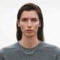 Georg Jensen Offspring Necklace in sterling silver on model wearing gray sweather | Kneen & Co