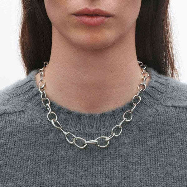 Georg Jensen Offspring Necklace in sterling silver on model with gray sweater | Kneen & Co