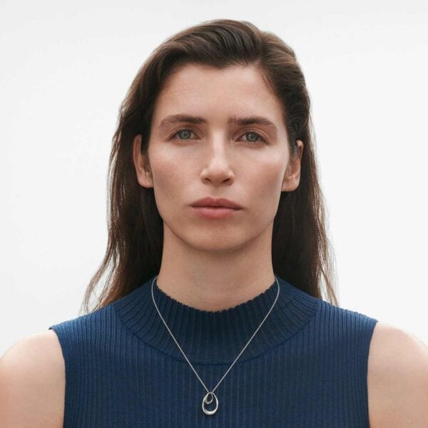 GJ-SS25-ECOM-SHOOT-OFFSPRING-NECKLACE-10012762-1200w-100KB Georg Jensen Offspring Large Pendant Necklace in Sterling Silver shown on model with blue top | Kneen & Co