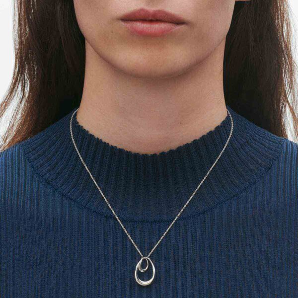 GJ-SS25-ECOM-SHOOT-OFFSPRING-NECKLACE-10012762-Close-up-1200w-100KB Georg Jensen Offspring Large Pendant Necklace in Sterling Silver close up on model in blue top| Kneen & Co