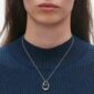 Georg Jensen Offspring Large Pendant Necklace in Sterling Silver close up on model in blue top| Kneen & Co