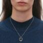 Close up of Georg Jensen Offspring Pendant 433B in sterling silver and 18 kt rose gold on model with blue top | Kneen & Co