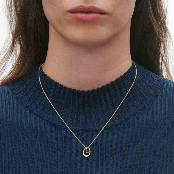 Georg Jensen Offspring Necklace with Pendant in 18kt yellow gold on model close up | Kneen & Co