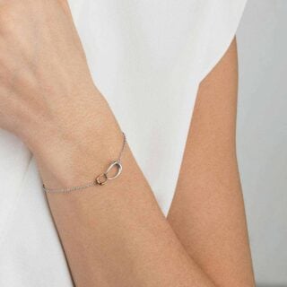 Georg Jensen Offspring Bracelet in sterling silver and 18 kt rose gold on model | Kneen & Co