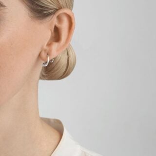 GJENSEN-10015148-MERCY-SWIRL-EARRING-634A-SLVR-1200w-100KB Georg Jensen Mercy Swirl Earring 634A in sterling silver shown on model | Kneen & Co