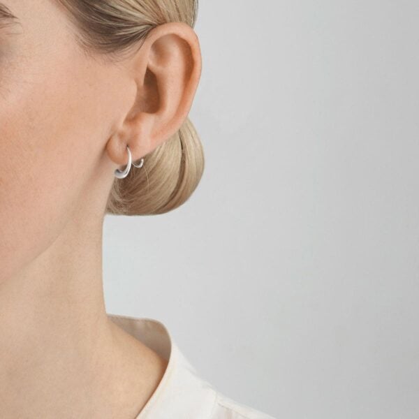 Georg Jensen Mercy Swirl Earring 634A in sterling silver shown on model | Kneen & Co