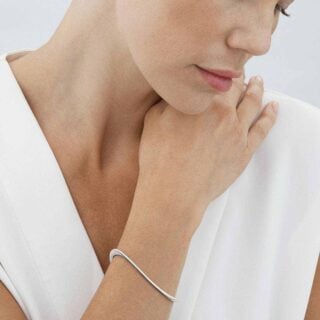Georg Jensen Offspring Slim Open Bangle Bracelet 1433D in Sterling Silver on model | Kneen & Co