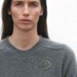 Georg Jensen Offspring Brooch, Small in 18 kt. yellow gold on model | Kneen & Co