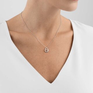 Woman wearing Georg Jensen Offspring Necklace with Pendant, Small in sterling silver | Kneen & Co