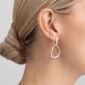 Georg Jensen Offspring Interlocked Earrings in sterling silver on model with blond hair | Kneen & Co