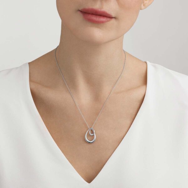 Georg Jensen Offspring Necklace with Pendant, Large 0.08 ct shown in woman in white top | Kneen & Co
