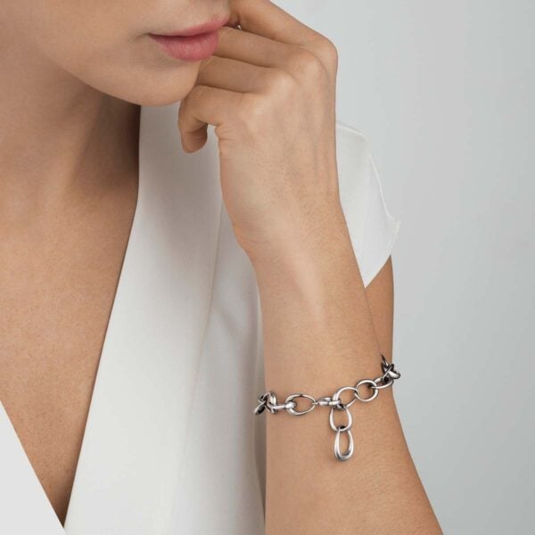 Woman wearing Georg Jensen Offspring Bracelet in sterling silver | Kneen & Co