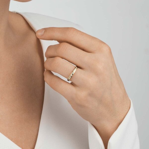 Woman wearing Georg Jensen Magic Ring 0.18 ct in yellow gold | Kneen & Co