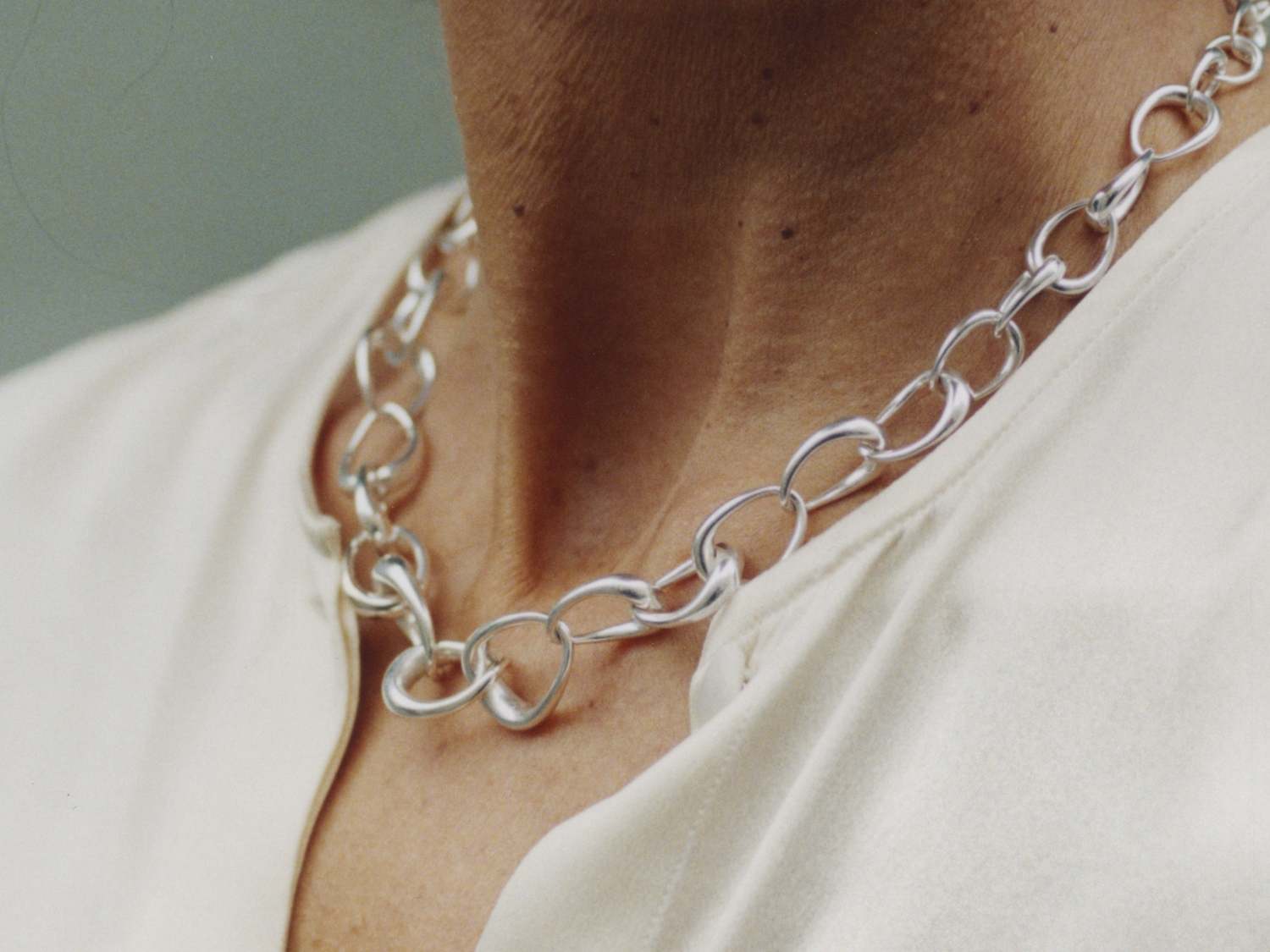 Woman wearing Georg Jensen Offspring Link Necklace in sterling silver | Kneen & Co