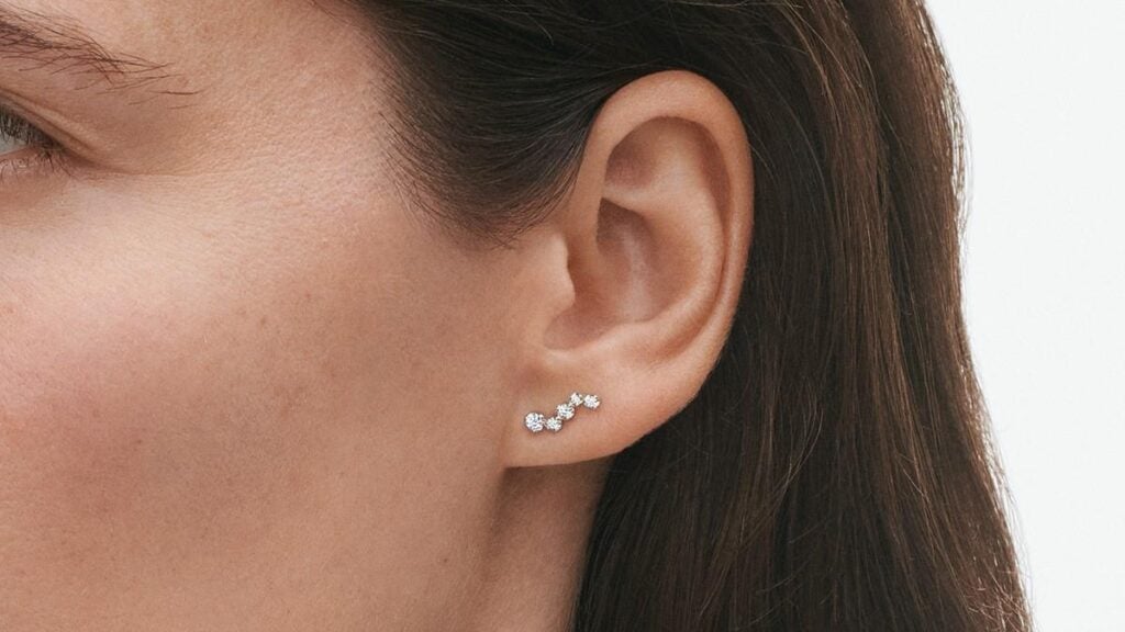 George Jensen Signature Woman wearing Diamonds Ear Stud White Gold With Diamonds 0.18 CT | Kneen & Co