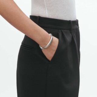 Woman wearing Georg Jensen Reflect ID Bangle Silver | Kneen & Co