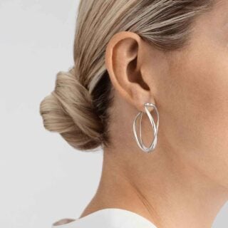 Woman wearing Georg Jensen Earhoop Silver | Kneen & Co