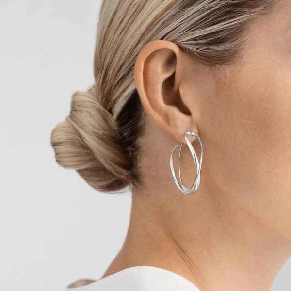 GJensen-3539267-INFINITY-EARHOOPS-STERLING-SILVER-LARGE-1200w-100KB Woman wearing Georg Jensen Earhoop Silver | Kneen & Co
