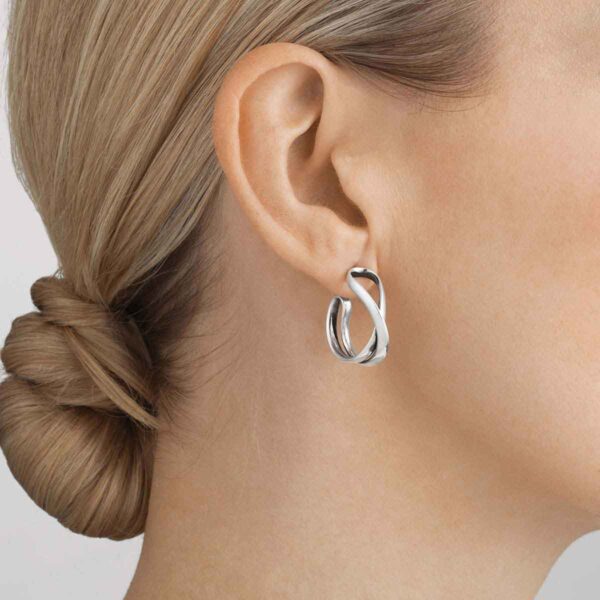 GJensen-3539283-Infinity-Earhoop-452A-S-1200w-100KB Woman wearing Georg Jensen Infinity Earhoops Silver | Kneen & Co