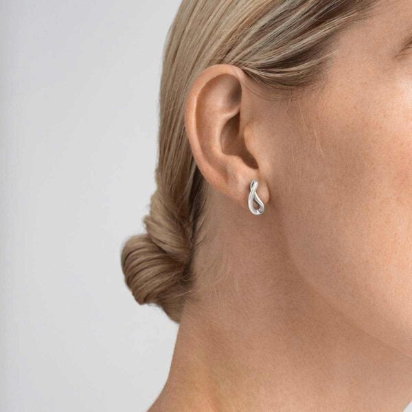 GJensen-3539284-INFINITY-EARRINGS-STERLING-SILVER-onmodel-1200w-100KB Woman wearing Georg Jensen Infinity Earrings Silver | Kneen & Co