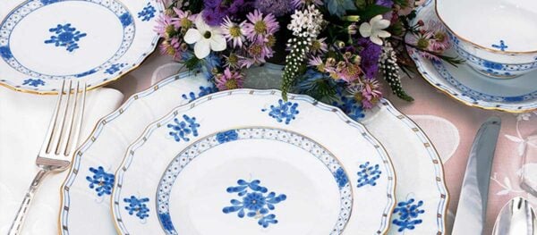 Herend Blue Garden Dinnerware set on table with flowers | Kneen & Co