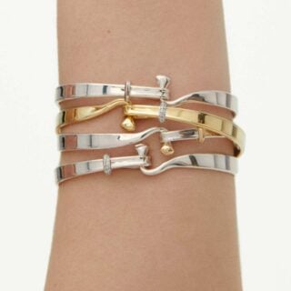 GJ-AW24-Torun-20000546-1200w-100KB Woman wearing Georg Jensen Torun Bangle assortment | Kneen & Co