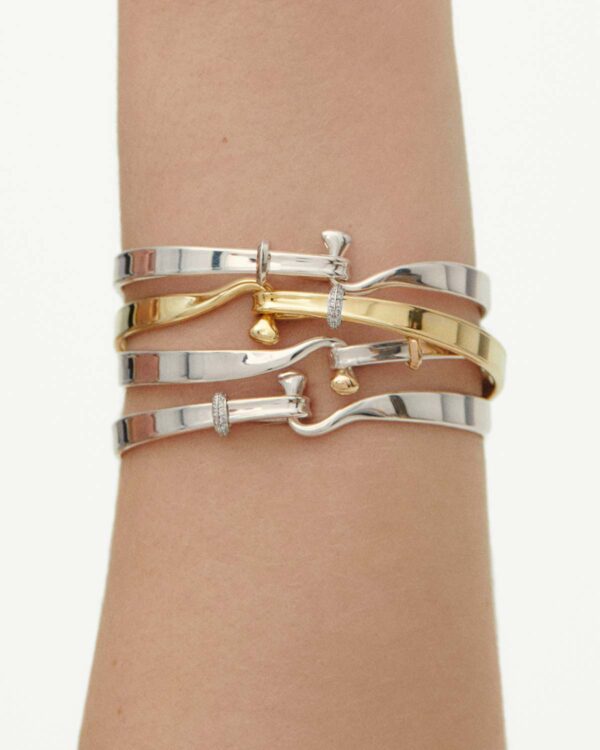 GJ-AW24-Torun-20000546-1200w-100KB Woman wearing Georg Jensen Torun Bangle assortment | Kneen & Co