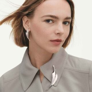 Woman wearing Georg Jensen Vivianna Torun jewelry | Kneen & Co