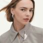 Woman wearing Georg Jensen Vivianna Torun jewelry | Kneen & Co