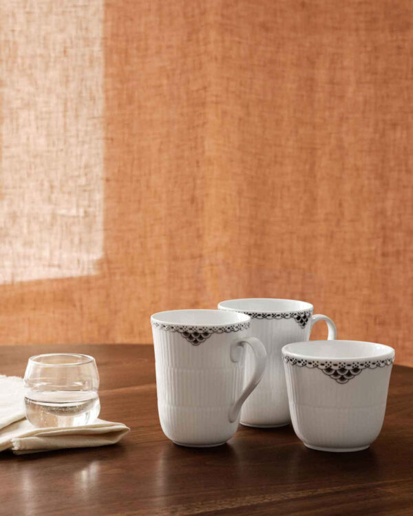 RC-BlackLace-Cup-36cl-2PK-Thermal-Mug-26cl-1200w-100KB Royal Copenhagen Black Lace Dinnerware Collection set on table | Kneen & Co
