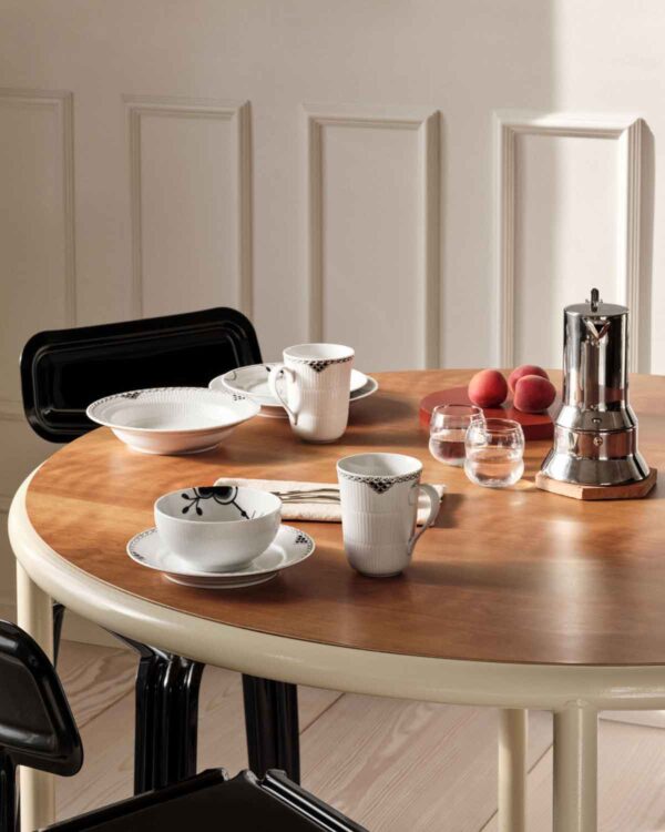 RC-BlackLace-Plate-19cm-Deep-Plate-21cm-Cup-36cl-2PK-BlackFluted-MegaBowl-47cl-TIF-1200w-100KB Royal Copenhagen Black Lace Dinnerware and Black Fluted Mega Dinnerware Collections set on table | Kneen & Co