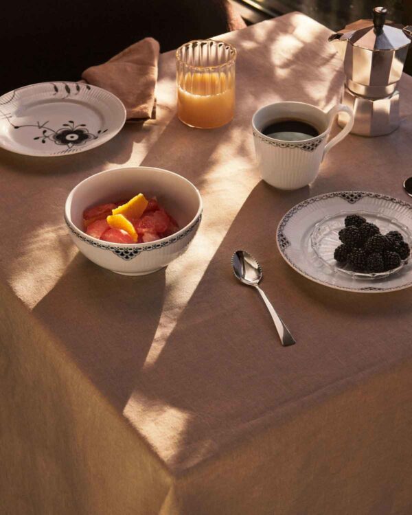 RC-S2-2024-LineExt-BlackLace-HH-Cup-33cl-Plate-22cm-Bowl-73cl-15cm-BlackFluted-MegaPlate-22cm-1200w-100KB Royal Copenhagen Black Lace Dinnerware and Black Fluted Mega Dinnerware Collections set on table | Kneen & Co
