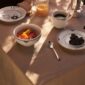Royal Copenhagen Black Lace Dinnerware and Black Fluted Mega Dinnerware Collections set on table | Kneen & Co