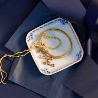 Royal Copenhagen Princess Square Assiette set on table with jewelry | Kneen & Co