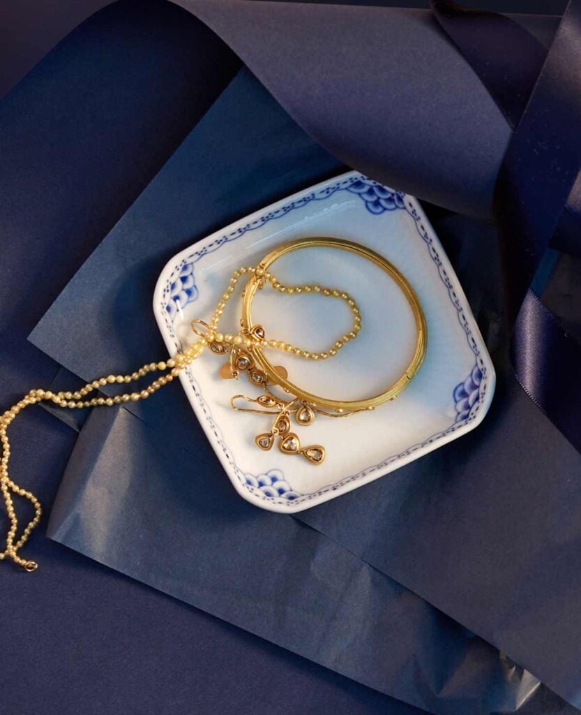 Royal Copenhagen Princess Square Assiette set on table with jewelry | Kneen & Co