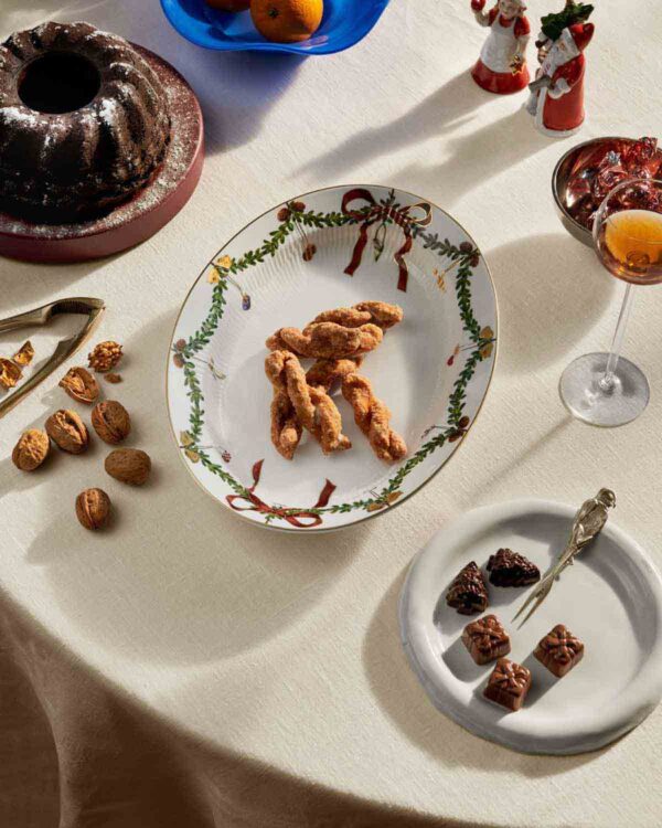 RC-S2-2023-Line-Extensions-1018147-Star-Fluted-Oval-Dish-34pt5cm-1200w-100KB Royal Copenhagen Star Fluted Christmas DInnerware set on table | Kneen & Co