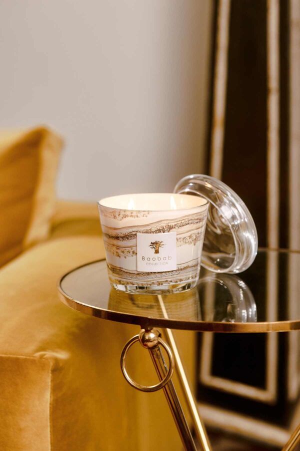 Golden interior setting with Baobab Collection candle in marbled glass with matching clear dome | Kneen & Co