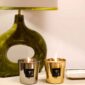 Modern bedside setting with Baobab Aurum and Platinum Les Exclusives Candle Duo in metallic gold and silver glass | Kneen & Co