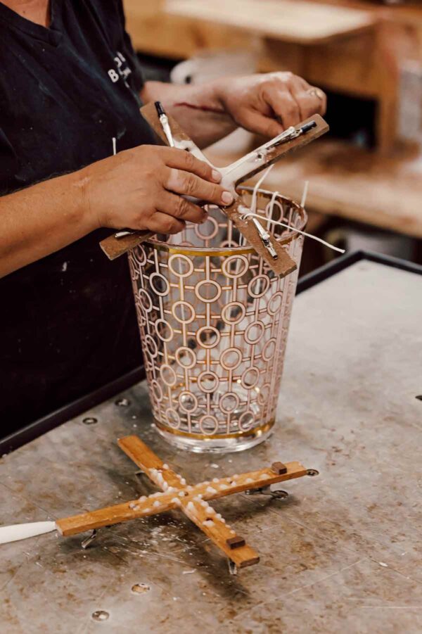 Craftsmanship workshop setting with Baobab Women Candle Max 10 in delicately printed glass with 24-carat yellow gold | Kneen & Co