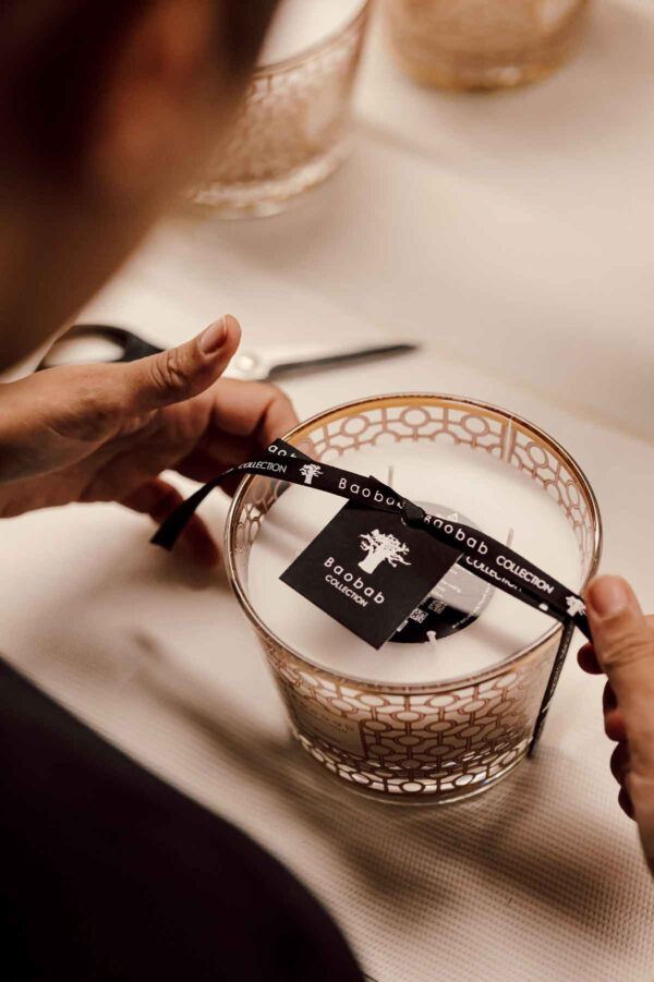 Artisanal workshop setting with Baobab Women Candle Max 10 in delicately printed glass with 24-carat yellow gold | Kneen & Co