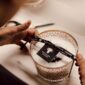 Artisanal workshop setting with Baobab Women Candle Max 10 in delicately printed glass with 24-carat yellow gold | Kneen & Co