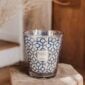 Cozy room environment with lit Baobab Gentlemen Candle Max 16 in graphic blue and silver glass | Kneen & Co