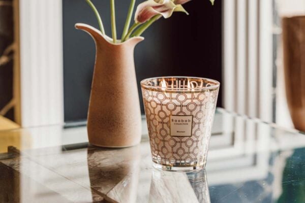 Bright interior setting with Baobab Women Candle Max 16 in delicately printed glass with 24-carat yellow gold | Kneen & Co